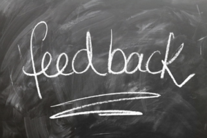 Customer feedback survey with the word feeback on a chalk board