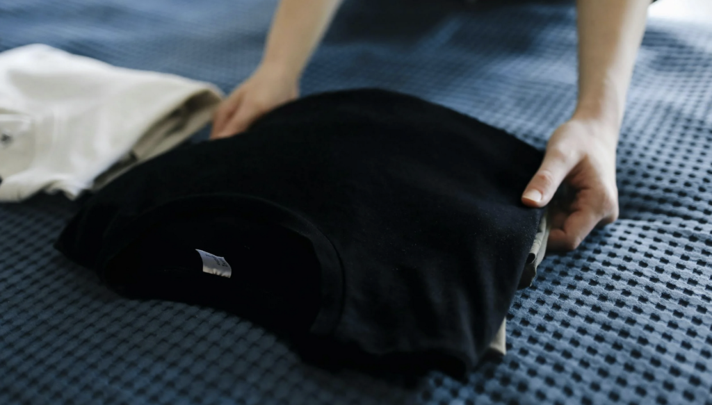 a person organizing a t shirt they ordered